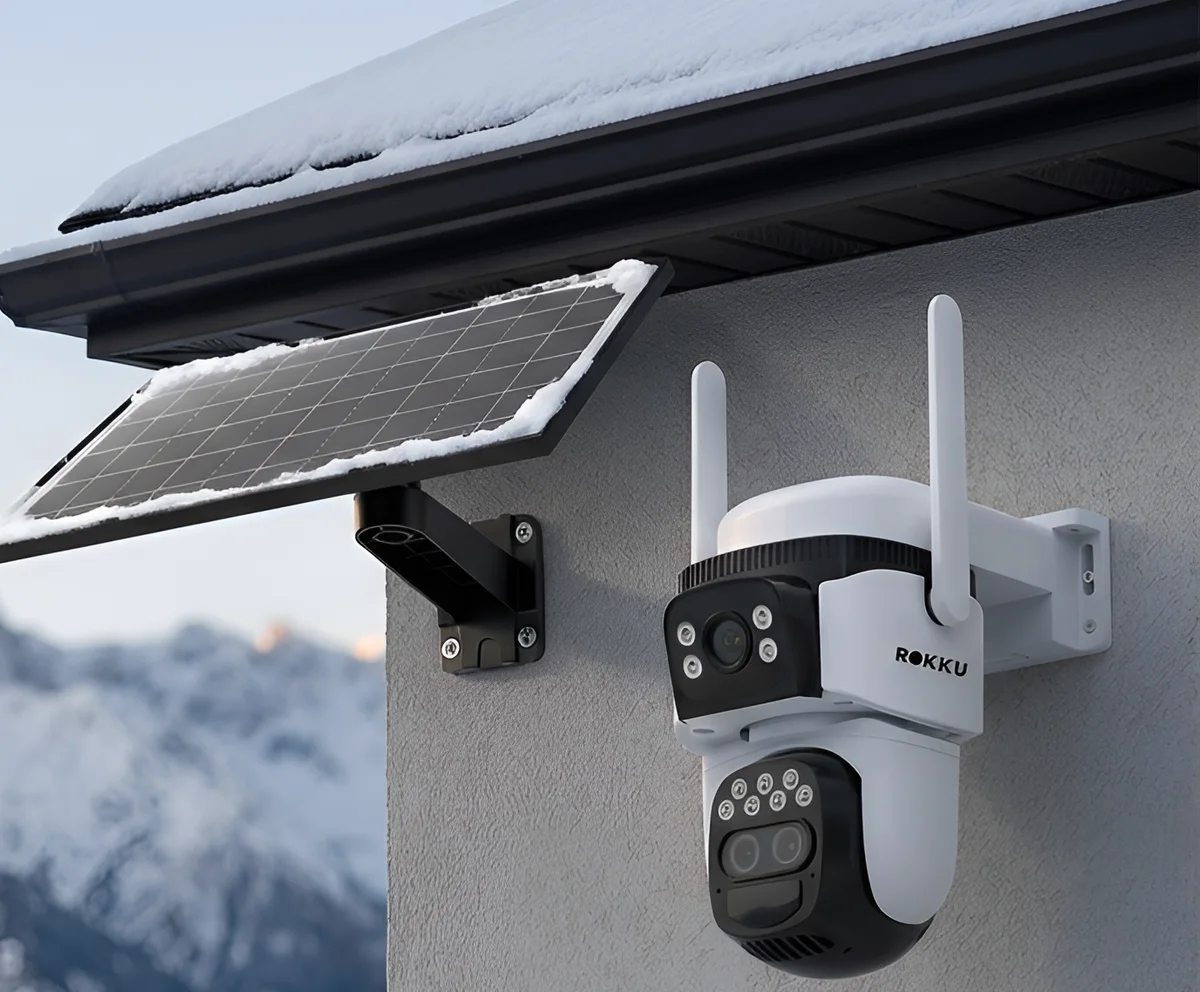 Rokku 4G SolariX Zoom outdoor camera with a solar panel on a house in the foothills in winter